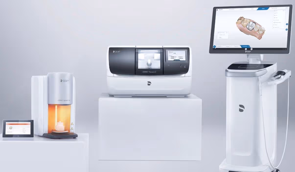 Three Dentsply Sirona CEREC devices displayed together: CEREC SpeedFire crystallization furnace, CEREC Primemill milling unit, and CEREC Primescan chairside workstation