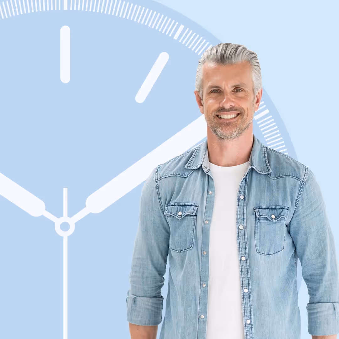 Smiling man with silver hair standing in front of a large illustrated clock on a light blue background, representing the convenience of a single-visit crown procedure