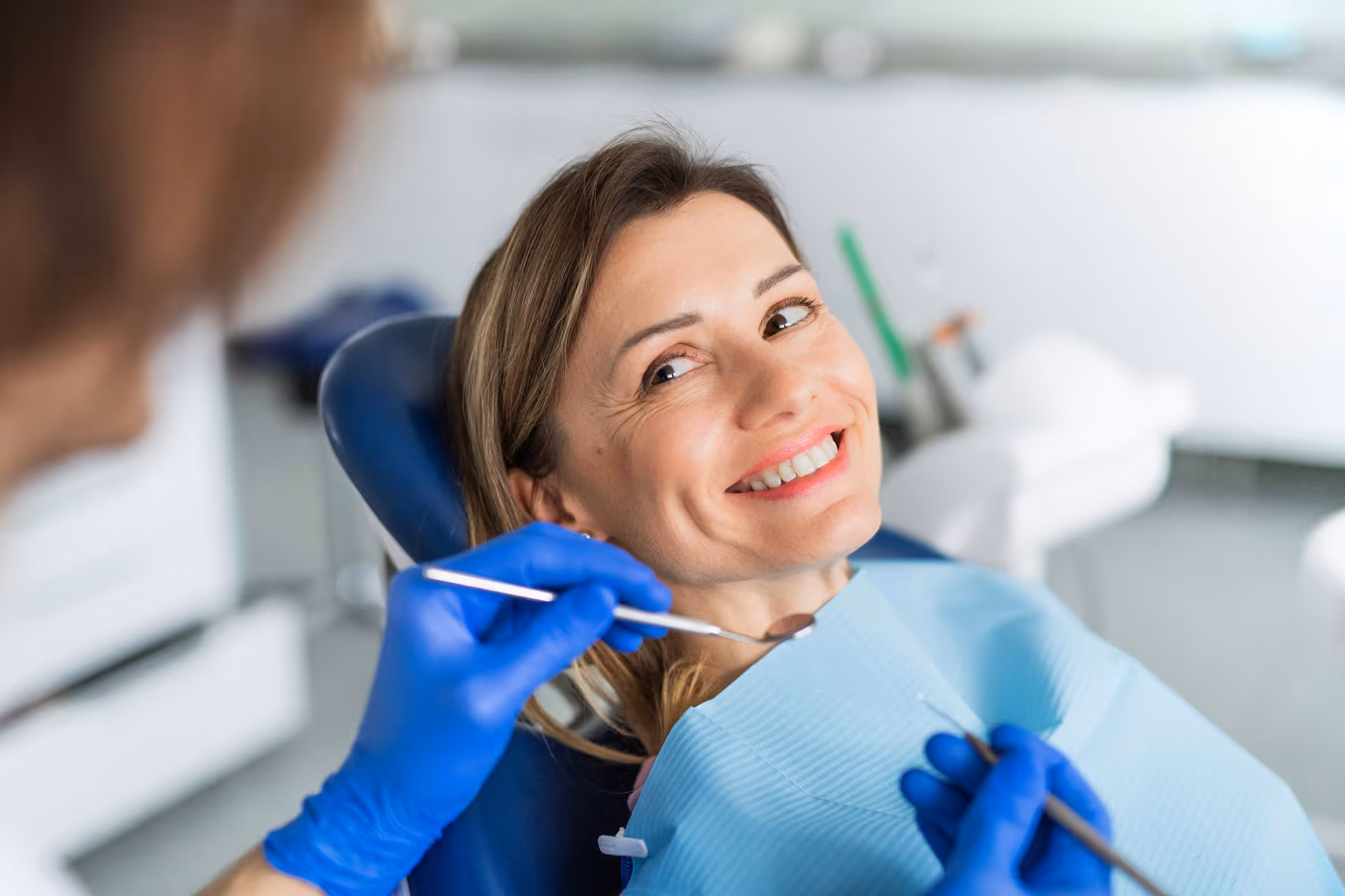 Dental patient happily smiling after crown placement